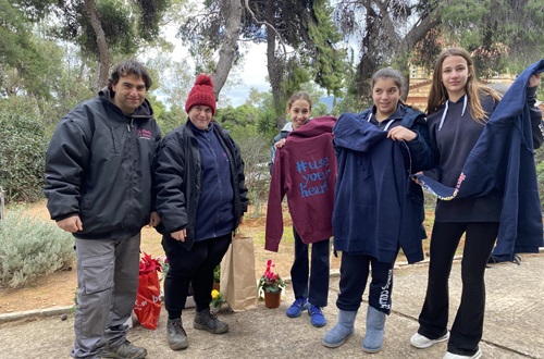 Members of the"Power of a Flower" Organization visit the Athens College Junior High School